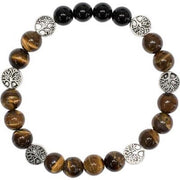 Bracelet with brown beaded design and silver tree of life charms on a white background