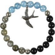 Bracelet with blue, black, and gray beads and a bird charm on a white background