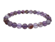 Purple beaded bracelet on a white background