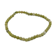 Green beaded bracelet on a white background