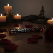 Black Love Hem Incense surrounded by candles and rose petals 