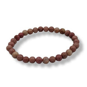Beaded bracelet with marbled pink and beige beads on a white background