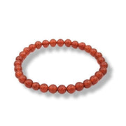 Red beaded bracelet on a white background