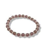 Bracelet with pink and white beads on a white background