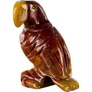 Carved stone parrot figurine on a white background