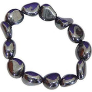 Hematite beaded bracelet with purple accents on a white background